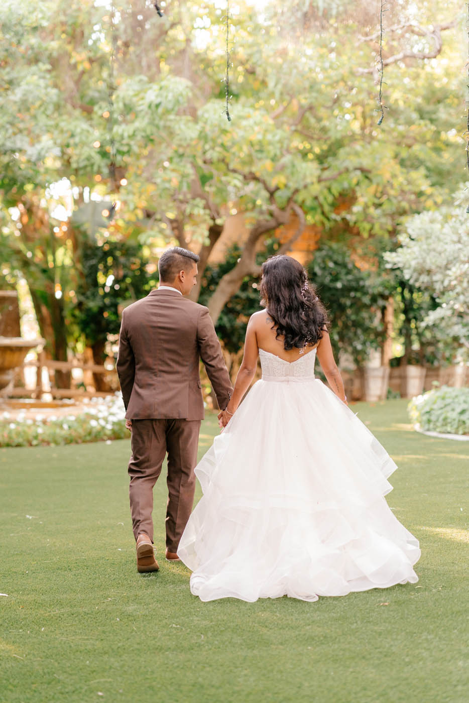 bride and groom walking at their souther California wedding venue