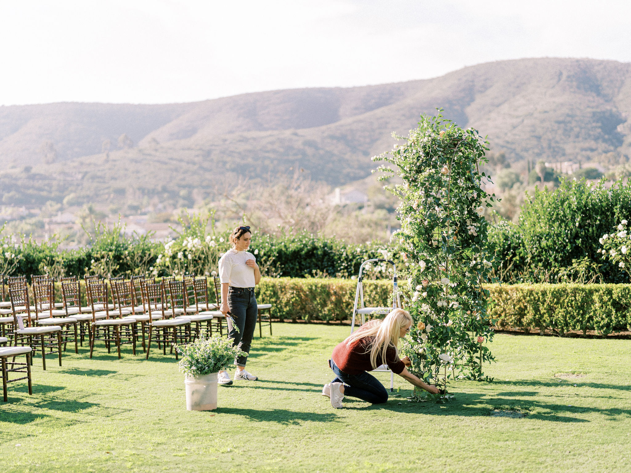 SISTI & CO. setting up for a Twin Oaks wedding in the outside garden ceremony area.
